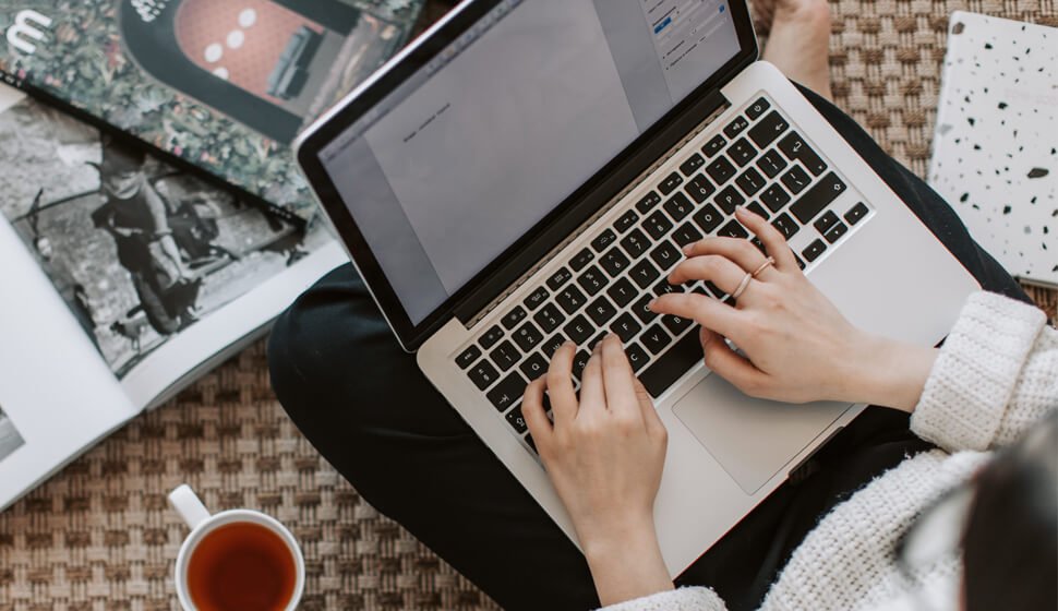 Person typing on a laptop at a desk